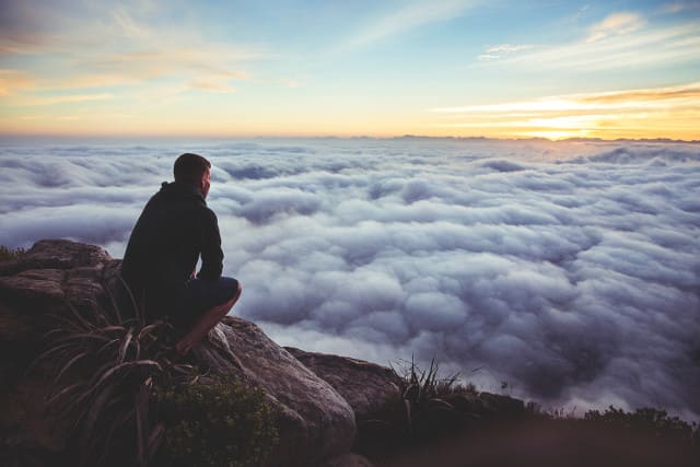 Man viewing clouds picture